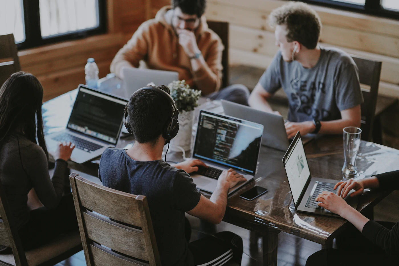 A small team working together on laptops around a table