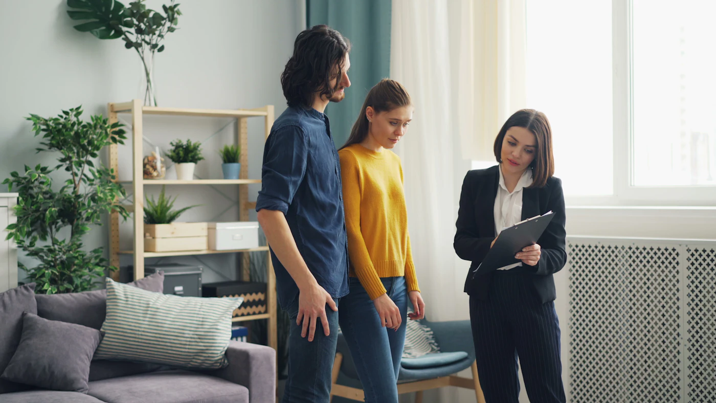 An estate agent showing a home to a young couple